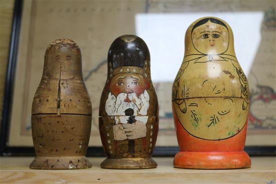 A Black Forest Bear string puppet, various Russian dolls and two carved figures